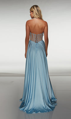 A woman in the Alyce 62064 long prom dress, a light blue strapless gown with a lace-up corset back and classic A-line silhouette, stands facing away against a plain background.