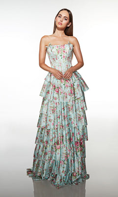 A woman wearing the Alyce 62066 long prom dress, featuring a strapless tiered ruffle skirt with a blue base and pink floral print, stands against a plain white background.