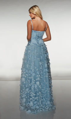 Woman wearing the Alyce 62072, a light blue long formal dress with a corset bodice and 3D floral-lace appliques, stands facing away from the camera.