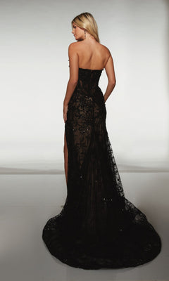 A woman with long blonde hair models the Alyce 62074 Long Prom Dress, a black lace strapless gown with a corset bodice and train, standing against a plain light background, shown from the back.