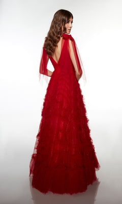 A woman with wavy brown hair wears the Alyce 62079 long prom dress in deep red tulle, featuring a layered A-line skirt and V-back, standing against a plain white background.