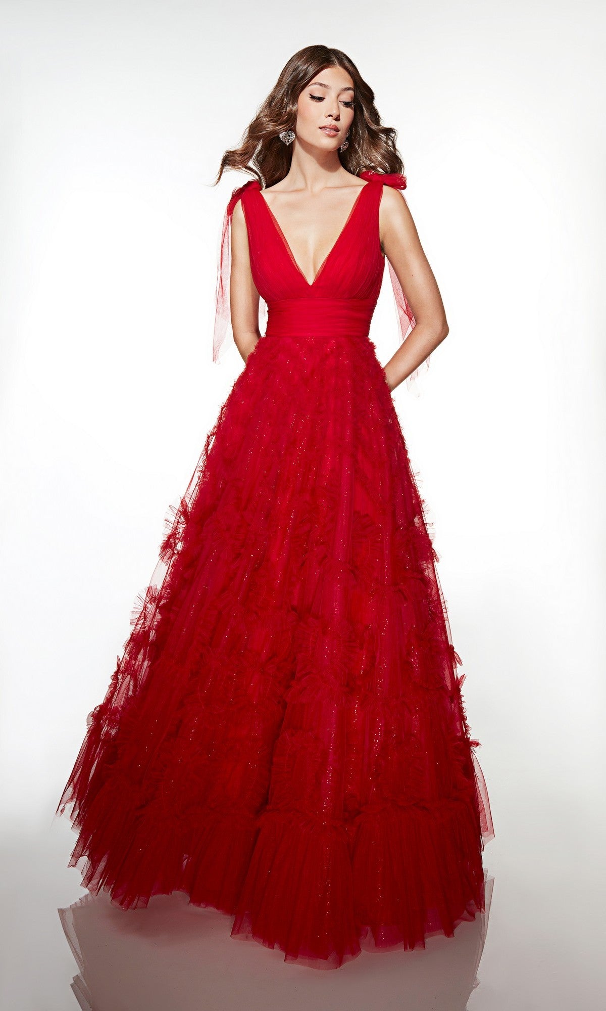 A woman models the Long Prom Dress: Alyce 62079, a floor-length, sleeveless red tulle gown with a deep V-neck and full A-line skirt, set against a plain white background.