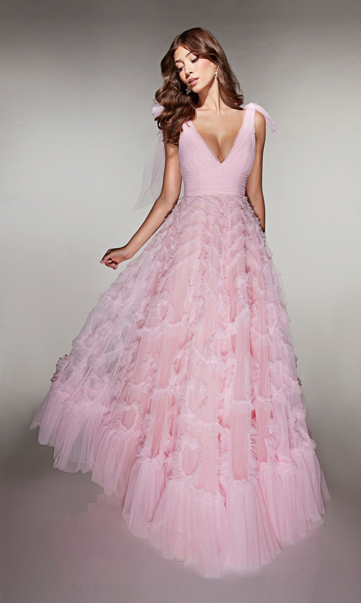 A woman models the Alyce 62079 long prom dress in rosewater, featuring a sleeveless deep V-neck bodice and layered A-line tulle skirt, floor-length, set against a plain background.