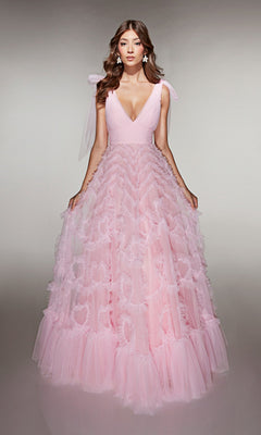 A woman stands facing forward in the Alyce 62079 long prom dress, a pale pink gown with a ruffled tulle A-line skirt, deep V-neckline, and delicate tulle details.