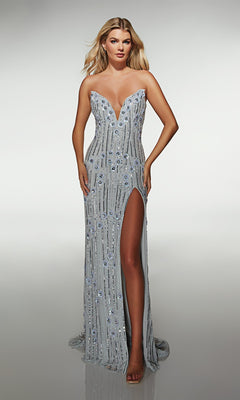 A woman poses against a plain background in the Alyce 62086 long prom dress, featuring a strapless silver design with a deep neckline, sequin embellishments, and a high slit.
