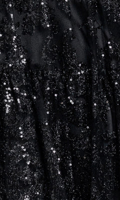Close-up of black fabric covered in small, shiny sequins creates a sparkly, textured pattern—perfect for the Strapless Mini Hoco Dress: Blondie Nites 6213BN, an ideal choice for a chic short A-line party dress or a standout black sequin homecoming dress.