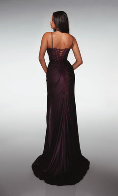 A woman stands with her back to the camera in the Alyce 62143 long formal dress, featuring a floor-length dark purple skirt, an embellished corset bodice, and lace-up back, set against a neutral background.