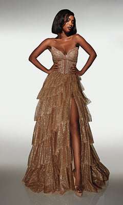 Wearing the Alyce 62144, a strapless long formal gown with a glittery tiered ruffle skirt and high slit, a woman stands confidently against a plain background—a showstopping pick for prom night.