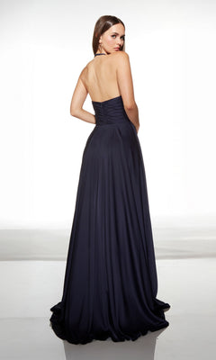 A woman faces away, wearing the Alyce 62152 Long Prom Dress—a floor-length navy satin gown with a fitted bodice and flowing skirt.