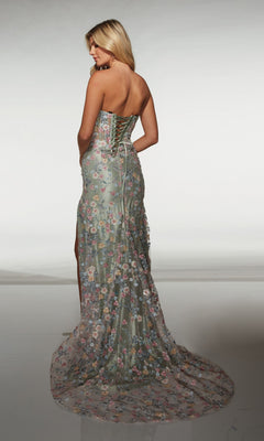 A woman faces away from the camera, wearing the Alyce 62178 Long Prom Dress with a strapless sweetheart neckline, lace-up back, and a floor-length skirt embellished with floral appliques that flow beautifully behind her.