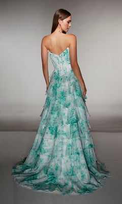 A woman is shown from the back wearing the Alyce 62192 long prom dress, a strapless gown with a green and white watercolor print and tiered chiffon ruffle skirt layers.