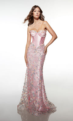 A woman stands against a plain white background wearing the Alyce 62197 Long Prom Dress—a strapless, fitted pink gown featuring a corset bodice, floral pattern, and sheer overlay.