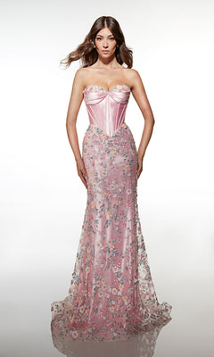 A woman poses against a plain white background wearing the Alyce 62197 long prom dress—a strapless pink gown featuring a corset bodice and delicate 3D floral embellishments.