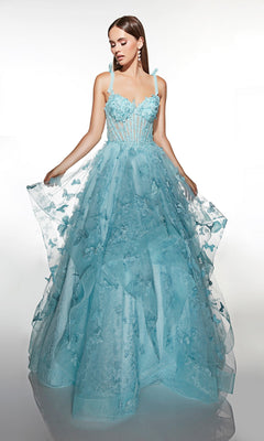 A woman poses against a white background in the Alyce 62199 long prom dress, a baby blue gown with floral and butterfly appliqué, a sheer corset bodice, spaghetti straps, and a tulle ballgown skirt.