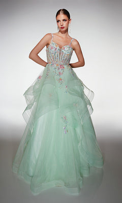 A woman poses gracefully in the Alyce 62201, a light green, floor-length formal dress featuring sheer layered tulle and delicate 3D floral appliques, set against a plain background.