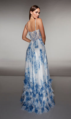 Woman in the Alyce 62202 long prom dress, featuring a sleeveless design, sheer back, blue and white floral patterns, and tiered ruffles, standing with her back to the camera.