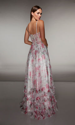 A woman wearing the Alyce 62202 long prom dress, featuring a sleeveless floral print, layered ruffled skirt, and sheer corset bodice, stands with her back to the camera.