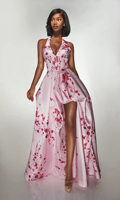 A woman models the Alyce 62214 long formal dress in cherry blossom, featuring a sleeveless floral satin design with a halter neckline and high slit, posed against a plain light background.