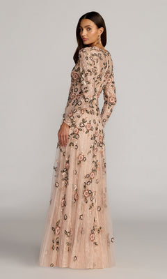 A woman wearing the Mac Duggal 6239 long formal dress in blush, featuring floral embroidery, stands and looks over her shoulder against a plain background. This elegant gown exudes timeless style and modern sophistication.
