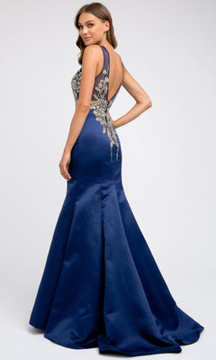 A woman wearing the Juliet 623 Long Prom Dress—a floor-length, royal blue gown with a fitted bodice, open back, and gold floral embroidery.