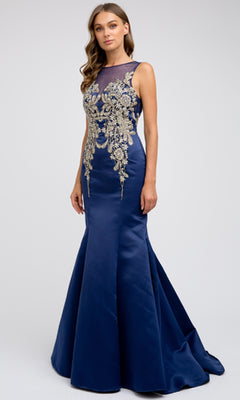 A woman wearing the Juliet 623—a sleeveless, floor-length navy blue prom dress with gold embroidery on the bodice—stands against a plain light background.