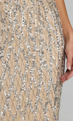 Close-up of the Mac Duggal 6249 long formal dress in beige, featuring silver sequin embellishments arranged in a geometric zigzag pattern, with part of a person’s hand visible on the right.
