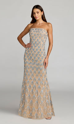 A woman poses elegantly with one hand on her hip against a plain background, wearing the Mac Duggal 6250 Long Formal Dress in Nude Silver—a strapless, floor-length evening gown intricately hand-beaded with shimmering silver and blue sequin patterns.