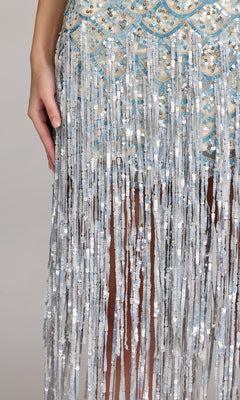 A person wearing the Long Formal Dress: Mac Duggal 6251, featuring silver beading, sequins, and fringe, shown from hip to knee with one hand at their side.