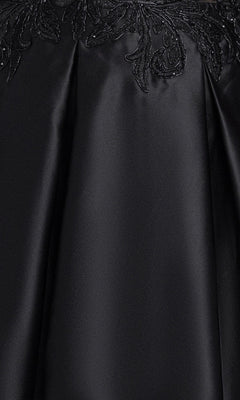 Close-up of smooth black satin fabric with visible pleats and floral embroidery detail at the top edge, highlighting the exquisite craftsmanship of the Plus-Size Black Hoco Dress: Blondie Nites 6346BNW—perfect for your next homecoming event.