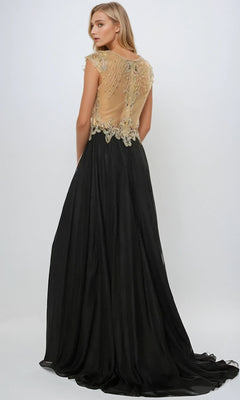 A woman faces away, wearing the Long Prom Dress: Juliet 636 featuring cap sleeves, a sheer back, and a flowing black A-line skirt, set against a plain light background.