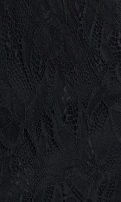 Close-up of black lace fabric with a floral pattern and sheer netting, showcasing the intricate details and texture of the Black Mini Hoco Dress: Blondie Nites 6372BN—perfect for a homecoming dress or mini hoco dress featuring a beaded corset.