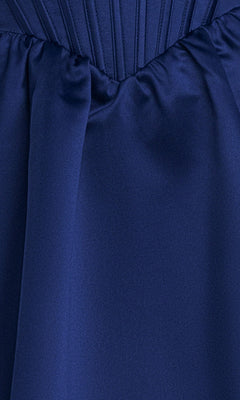Close-up of blue satin fabric with gathered and pleated details, featured on the Navy Blue Mini Hoco Dress: Blondie Nites 6377BN.