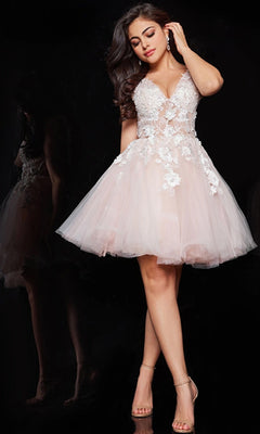 A woman models the Jovani Short Babydoll Homecoming Dress in light pink tulle with floral lace, V-neckline, and spaghetti straps, posing elegantly against a black background.