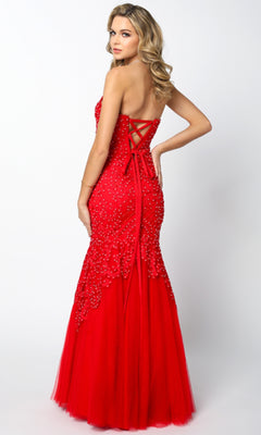 A woman poses in the Juliet 644 Long Mermaid Prom Dress, a red strapless gown with a lace-up back and bead embellishments—ideal for formal events.