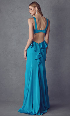 A woman stands facing away from the camera in the Juliet 645 long prom dress, featuring a teal color, open back, and ruffle detail, set against a gray background.