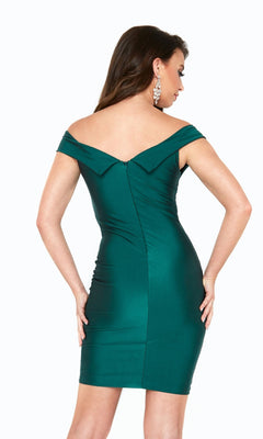 A woman faces away from the camera, featuring the Atria Off-the-Shoulder Short Hoco Dress 6519S in fitted emerald green, set against a crisp white background.