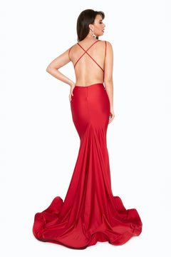 A woman, back to the camera on a white background, models the Strappy-Back Long V-Neck Prom Dress 6534H—featuring a floor-length skirt, open back with crisscross straps, and a low V-neck.