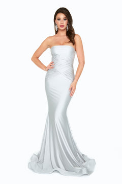 A woman poses with one hand on her hip in the Ruched-Waist Strapless Long Prom Dress: 6538H, featuring a ruched silver bodice, against a plain white background.