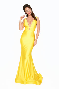 A woman wearing the Atria 6539H Waistband Deep V-Neck Long Prom Dress, a sleeveless yellow mermaid gown, stands against a white background.