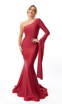 A person models the Drape One Long-Sleeve Long Prom Dress: Atria 6546H, a fitted, floor-length, one-shoulder formal gown with a flared hem and single long sleeve, standing against a plain white background.