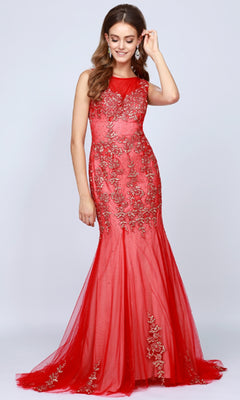 A woman wearing the Long Prom Dress: Juliet 656, a sleeveless mermaid gown with floral embroidery, stands against a plain light background, smiling and touching her hair.