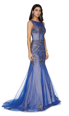 A woman models the Long Prom Dress: Juliet 656—a sleeveless, floor-length blue gown with sheer fabric and intricate gold embellishments—against a white background. This sparkly dress is perfect for making an entrance at prom.