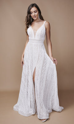 A woman poses against a plain beige background, wearing the Nina Canacci 6617 long formal dress—a sleeveless white gown with an A-line skirt, fitted waist, low V-neckline, and front slit.