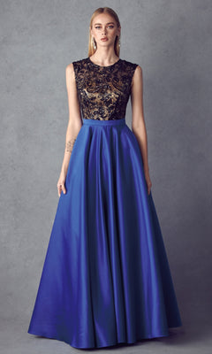 A woman wears the Cut-Out Long A-Line Prom Dress: Juliet 661, featuring an embellished black and gold bodice and a flowing royal blue skirt, as she stands against a plain gray background.