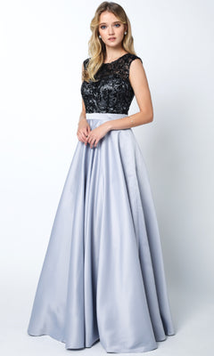 A woman wears the Juliet 661 Cut-Out Long A-Line Prom Dress in silver/black, featuring an embellished bodice and a flowing satin skirt, standing against a plain white background.