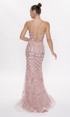 A woman faces away, wearing the Nina Canacci 6625 long formal dress in mauve pink with sequins, crisscross straps, and floral details.
