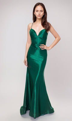 A woman poses against a plain background in the Nina Canacci 6632 long formal dress, featuring fitted emerald green satin, spaghetti straps, and a deep neckline in a classic mermaid style.