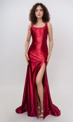 A woman models the Nina Canacci 6633—a sleeveless, floor-length red formal dress with a square neckline and thigh-high slit—standing against a simple light background.