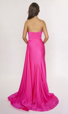 A woman faces away, wearing the Nina Canacci 6686— a bright pink, strapless long formal dress with a dramatic thigh-high slit and long train, set against a plain light background.