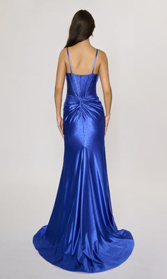A woman with long brown hair is photographed from behind wearing the Nina Canacci 6687 long formal dress in royal blue, featuring thin straps and rhinestone embellishments on the gathered back.